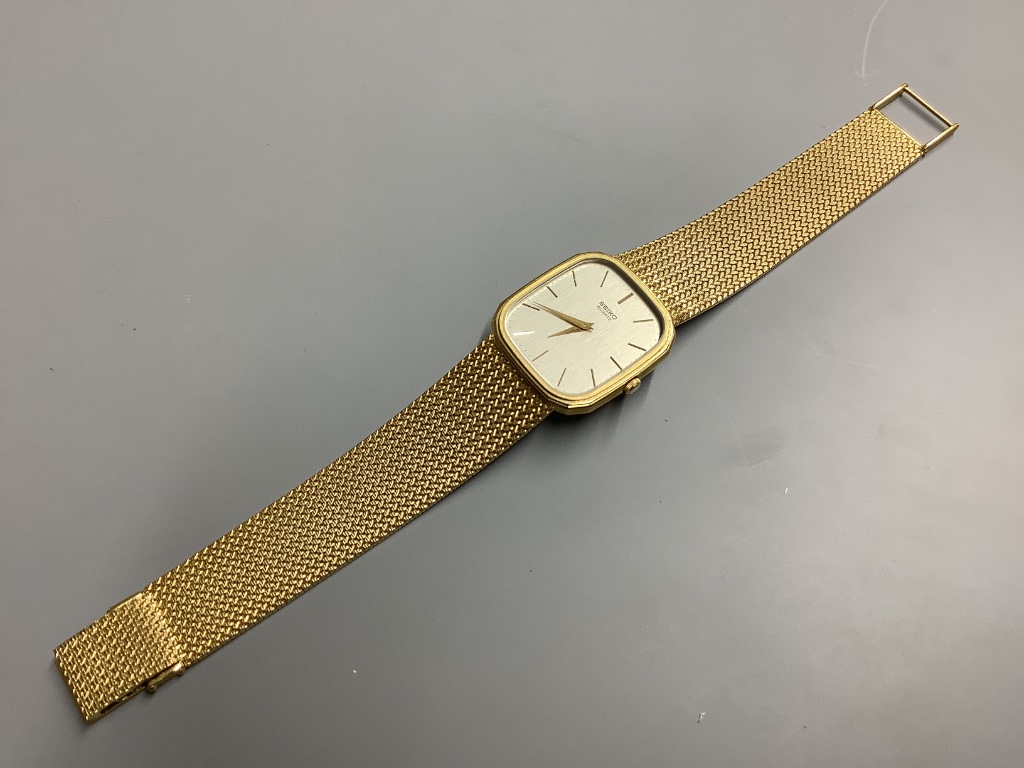 A gentleman's modern 9ct gold Seiko quartz wrist watch on integral 9ct gold mesh link bracelet. overall 20.5cm